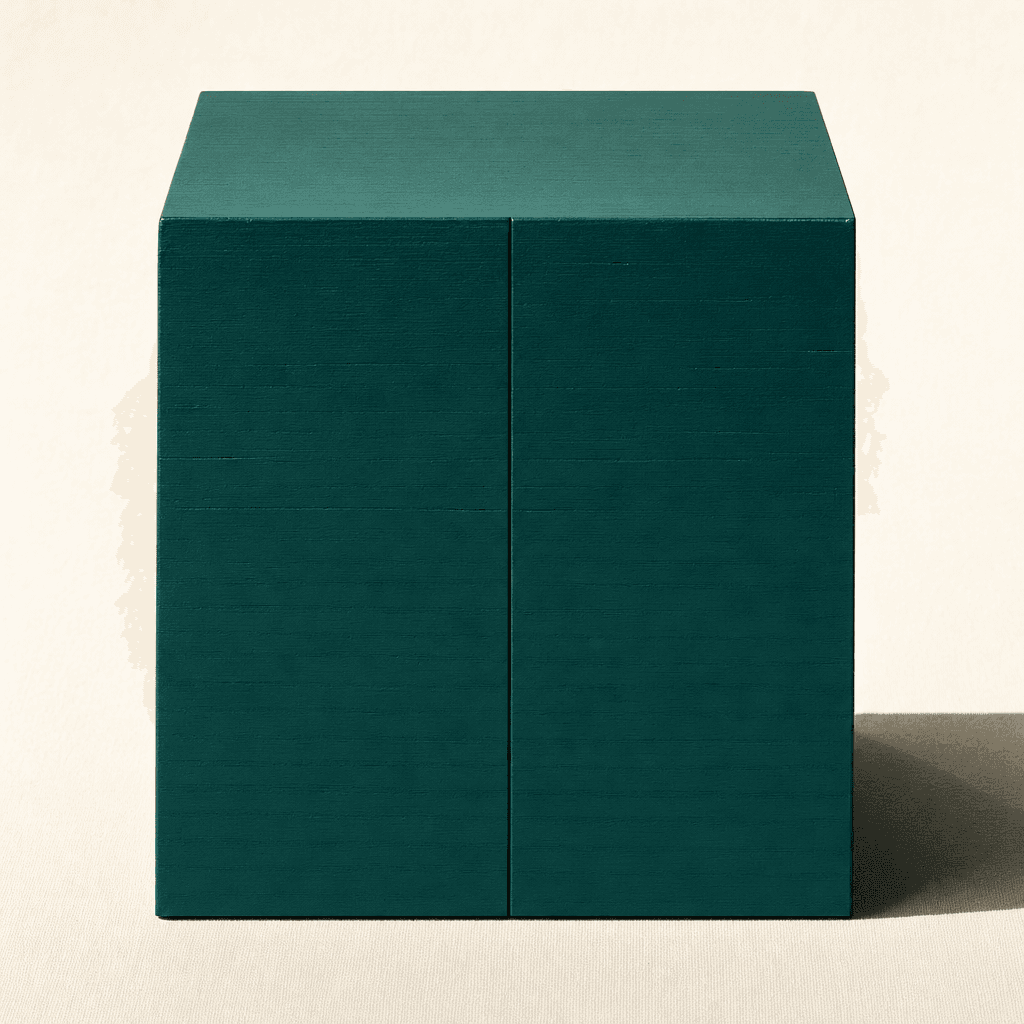 A monolithic matte deep-teal block on a cream surface with a hairline seam down the front — sealed, sovereign, contained.